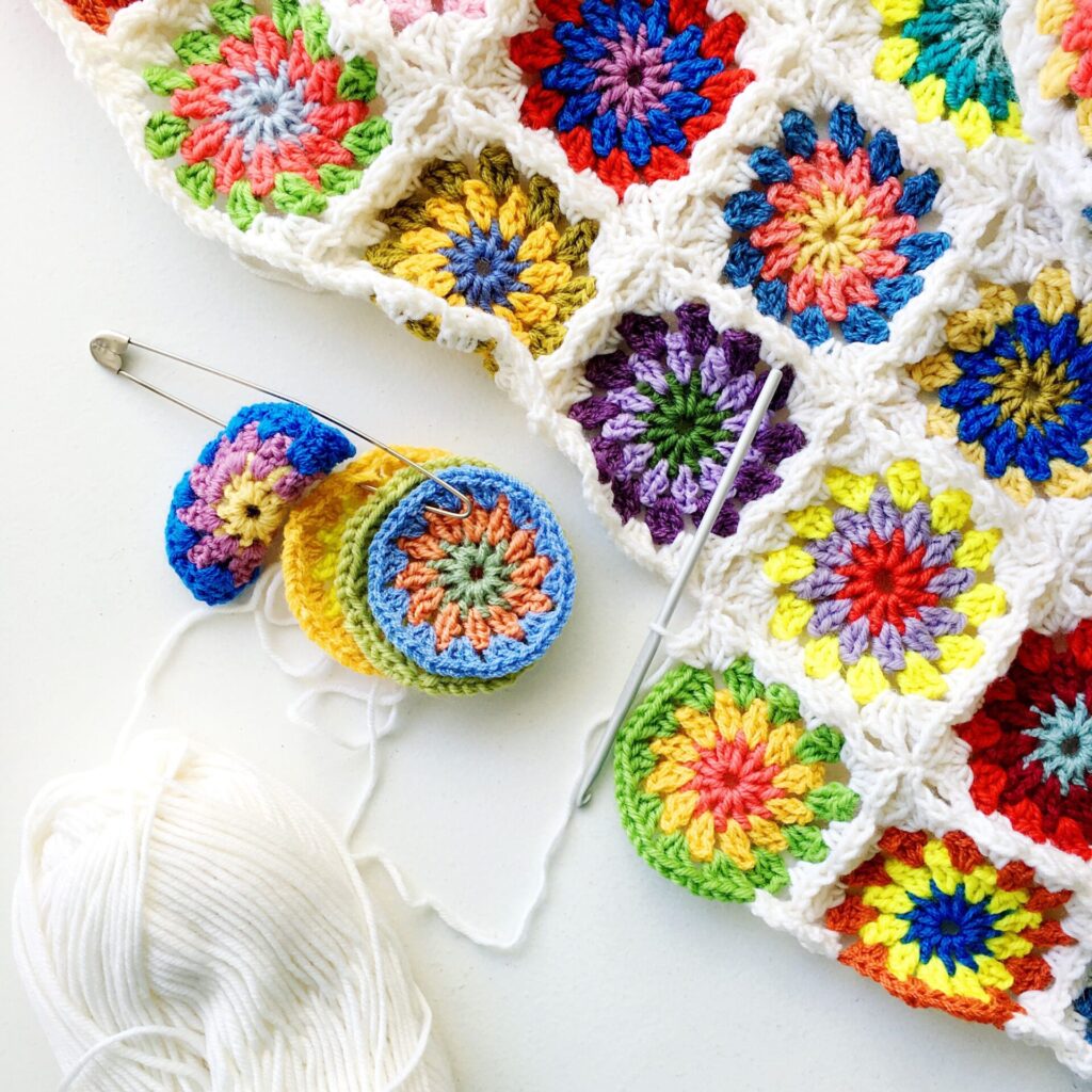 Joined colourful crochet squares as used for a bed cover.