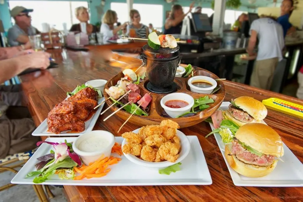 Mixedpeople in tables of 4 eating in a restaurant or cafe