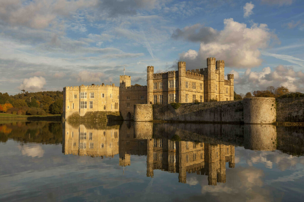 Leeds Castle, sunlit and reflected in the moat.